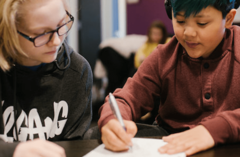 two students working together on a writing assignment