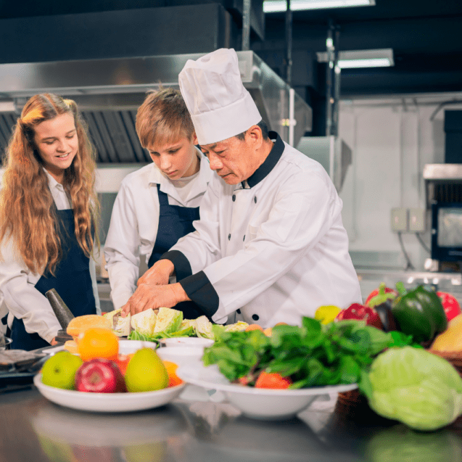 students learning to cook with a chef