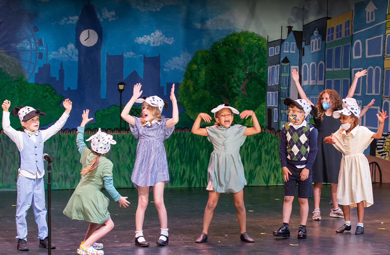 young children performing a musical theatre show on stage
