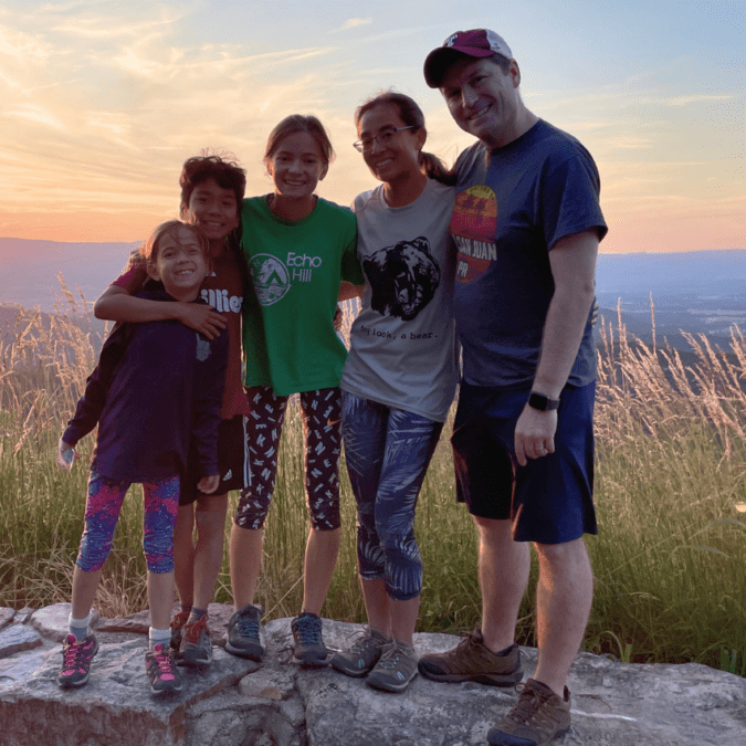 Brinker family posting in front of a sunset.