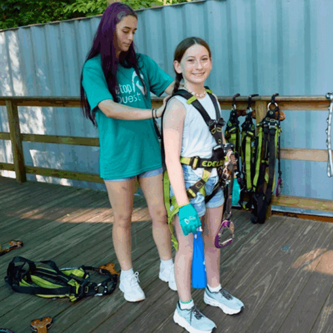 Getting fitted with a harness at Treetop Quest Philly