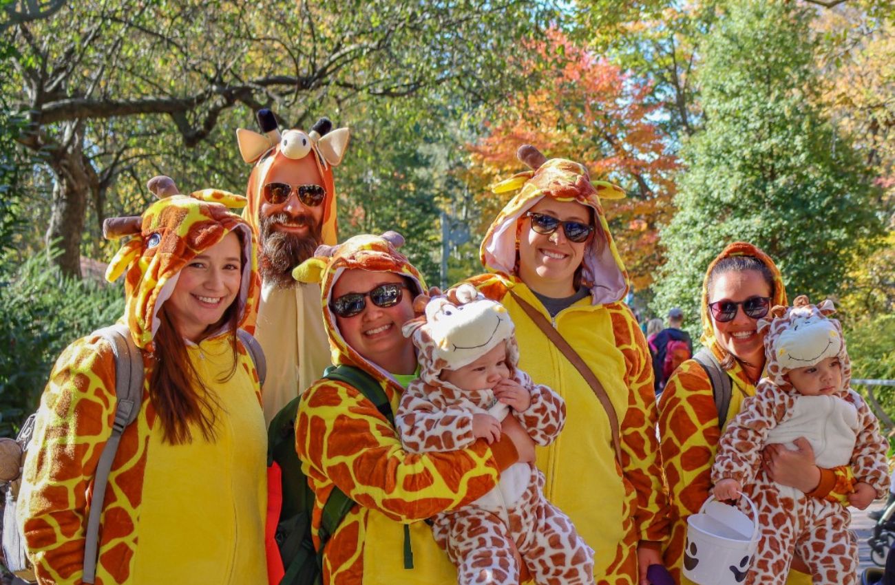A family with two babies all in giraffe costumes celebrate Halloween at the Philadelphia Zoo's Boo at the Zoo.