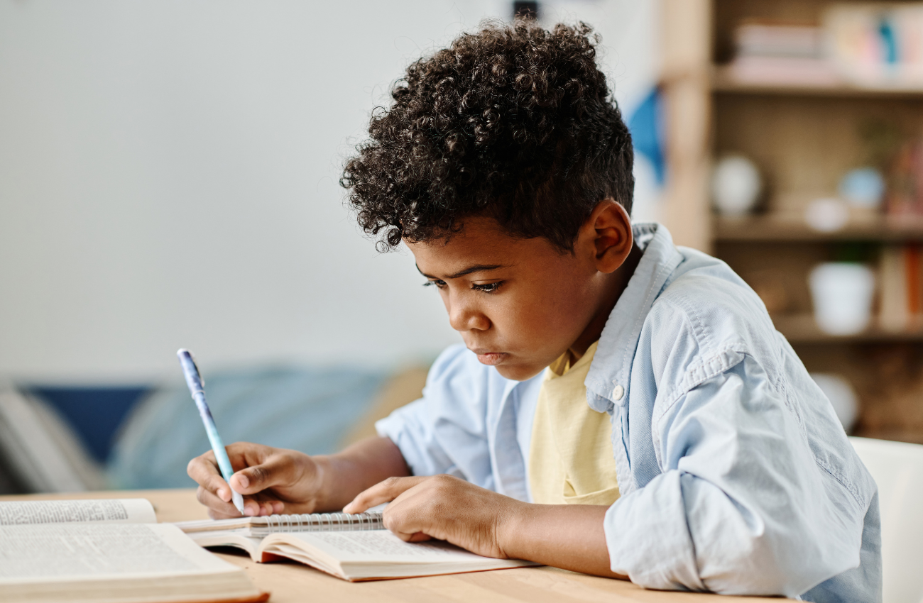 child doing schoolwork at a desk