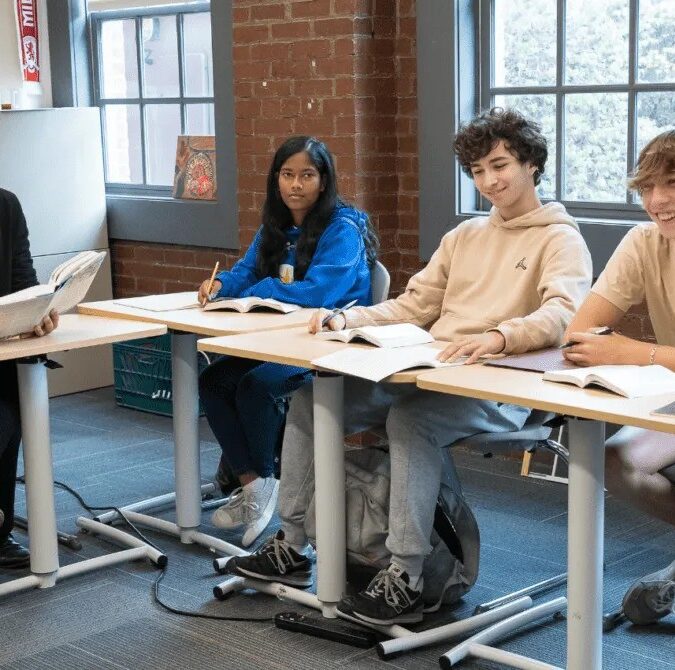 AIM Academy students attend a class with a teacher