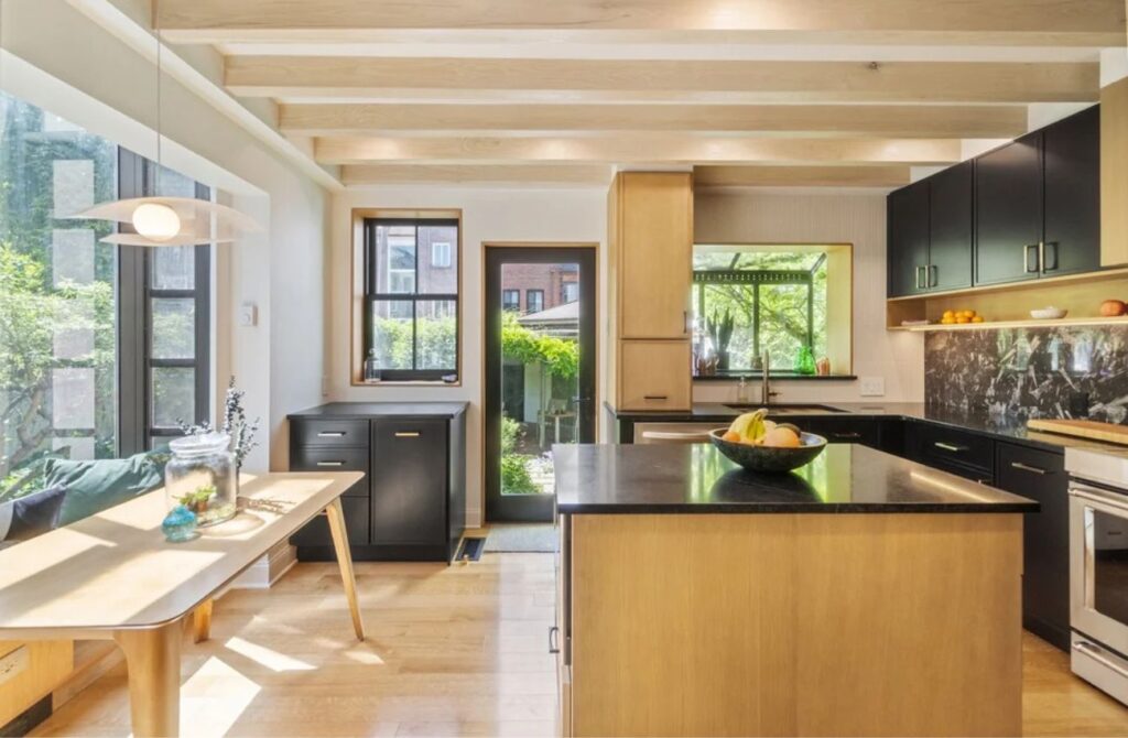A modernized row home interior with added windows and storage by Match Remodeling. 