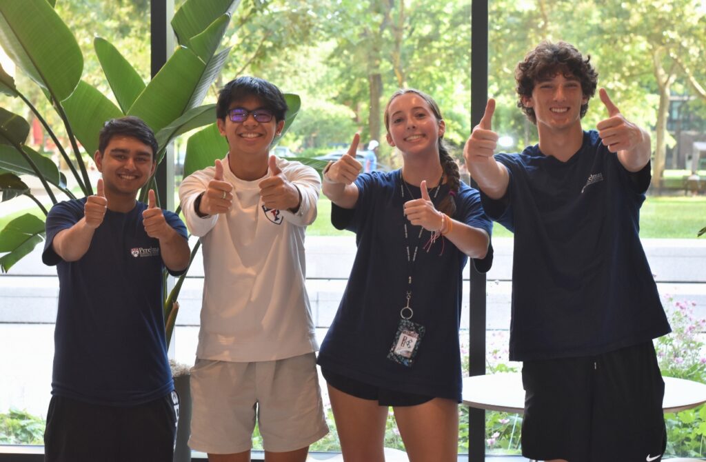 Campers at ESF posing for the camera in an atrium during their day