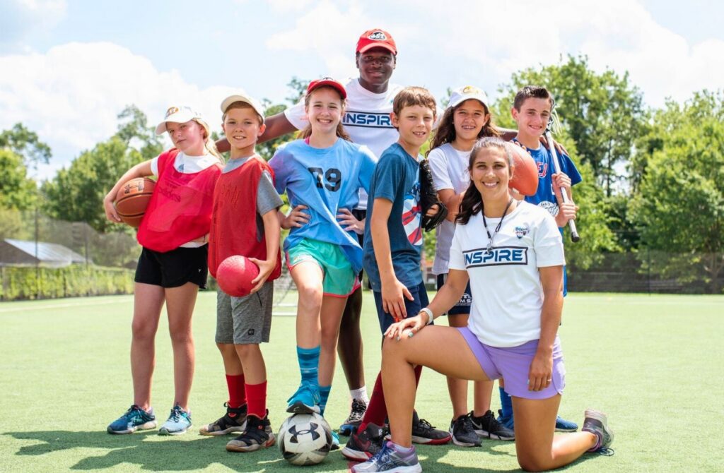 ESF Campers and staff posting together on a turf field