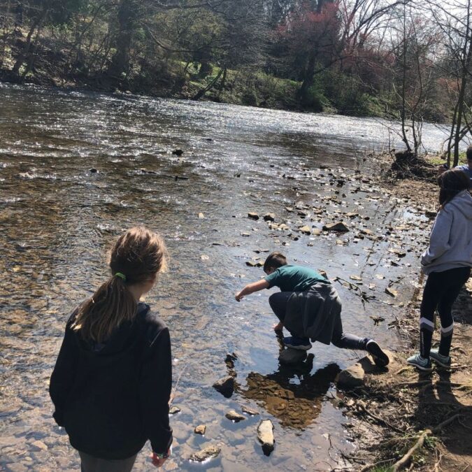 Kids explore a creek in Chester County, PA while hiking as a family in the Philadelphia area.