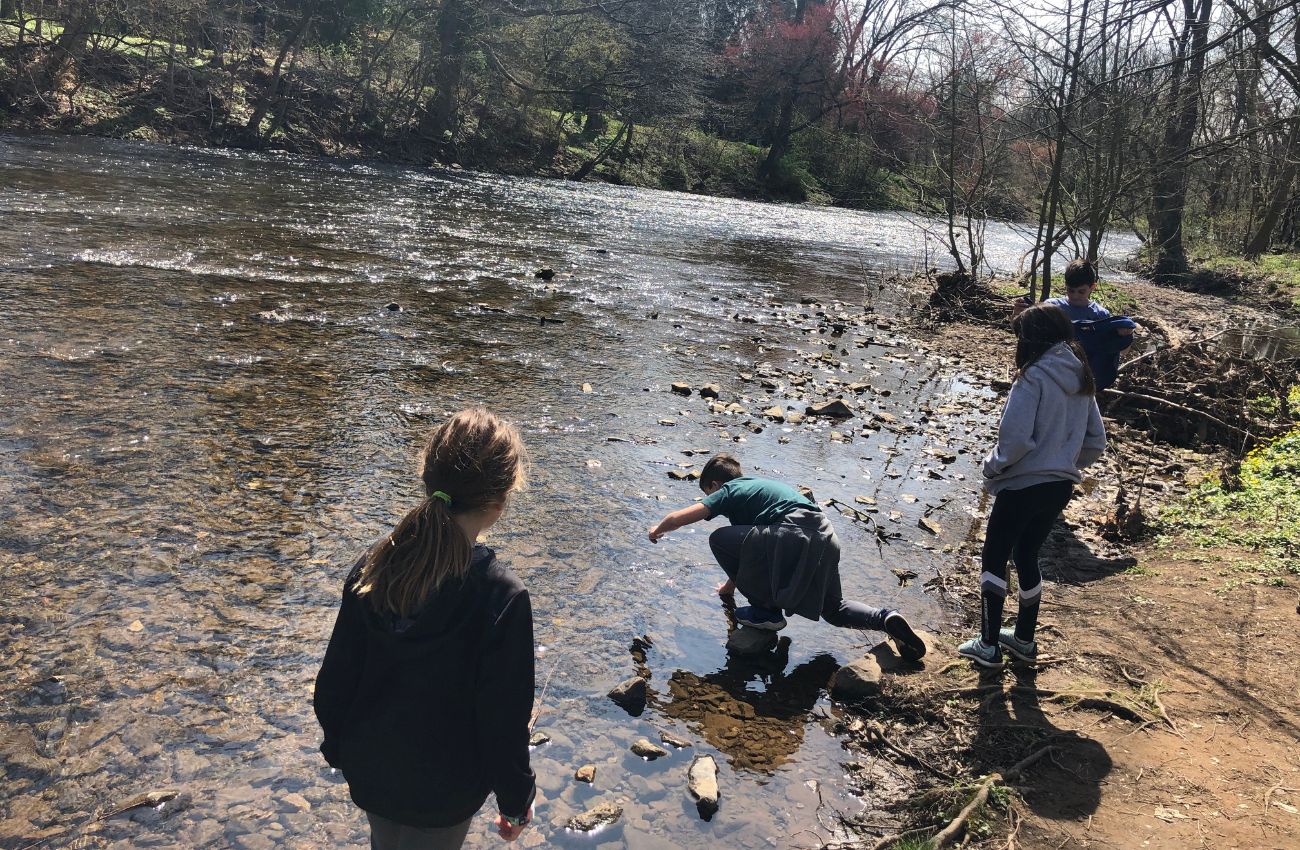 Kids explore a creek in Chester County, PA while hiking as a family in the Philadelphia area.
