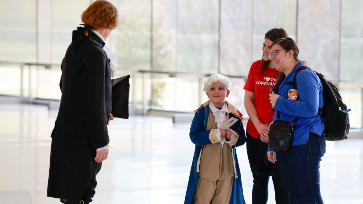 A young boy in colonial costume greets a president during Presidents Day weekend at the National Constitution Center in Philadelphia.