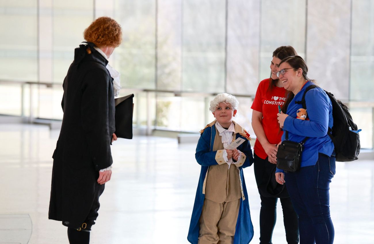 A young boy in colonial costume greets a president during Presidents Day weekend at the National Constitution Center in Philadelphia.