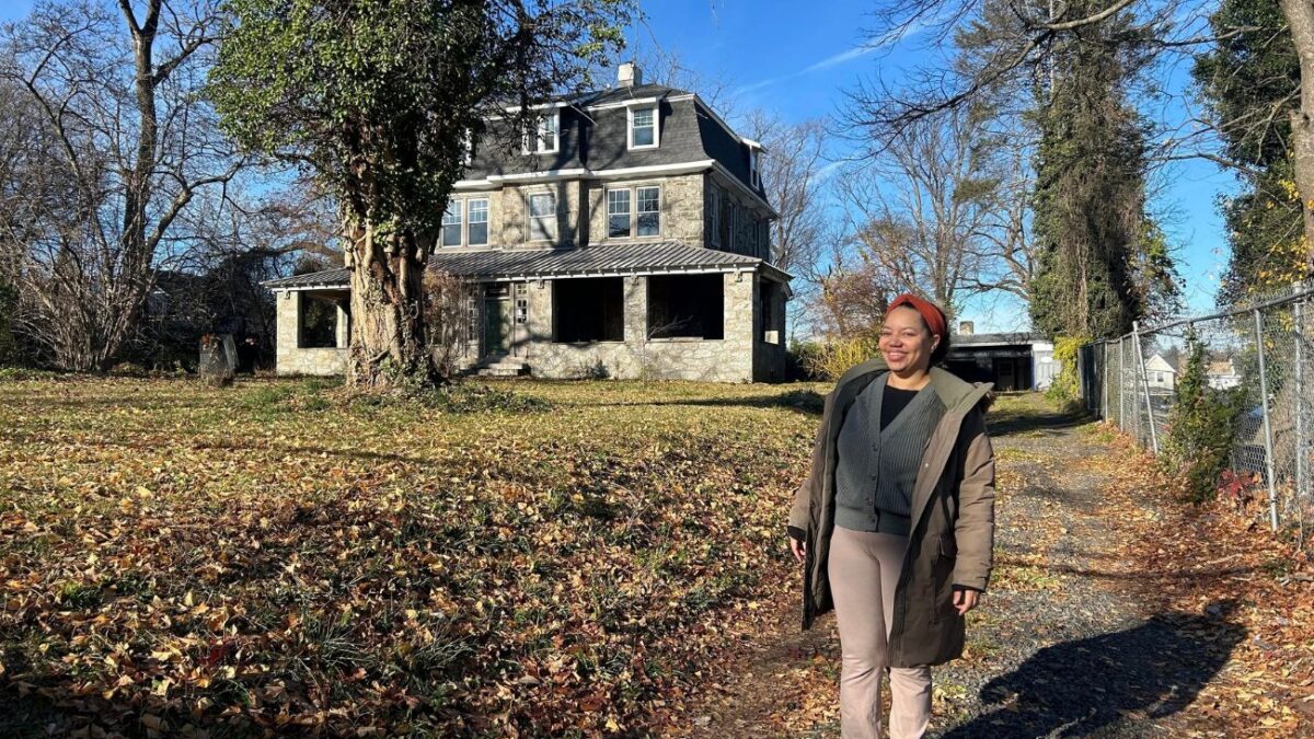 Philadelphia Midwife Collective director, Autumn Nelson stands in front of the Germantown house that will be the new birth center.
