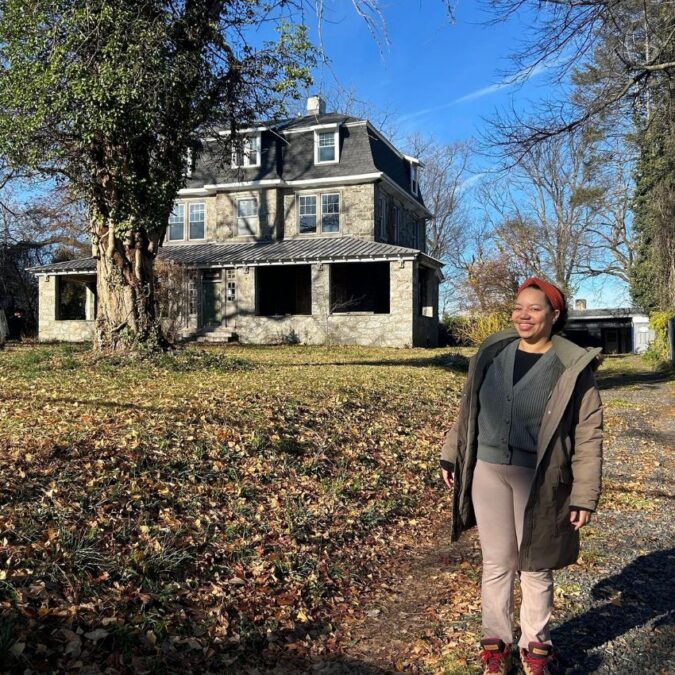 Philadelphia Midwife Collective director, Autumn Nelson stands in front of the Germantown house that will be the new birth center.