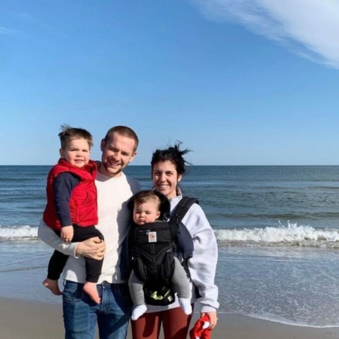 Small Moments founder, Rebecca with her husband and two kids on the beach.