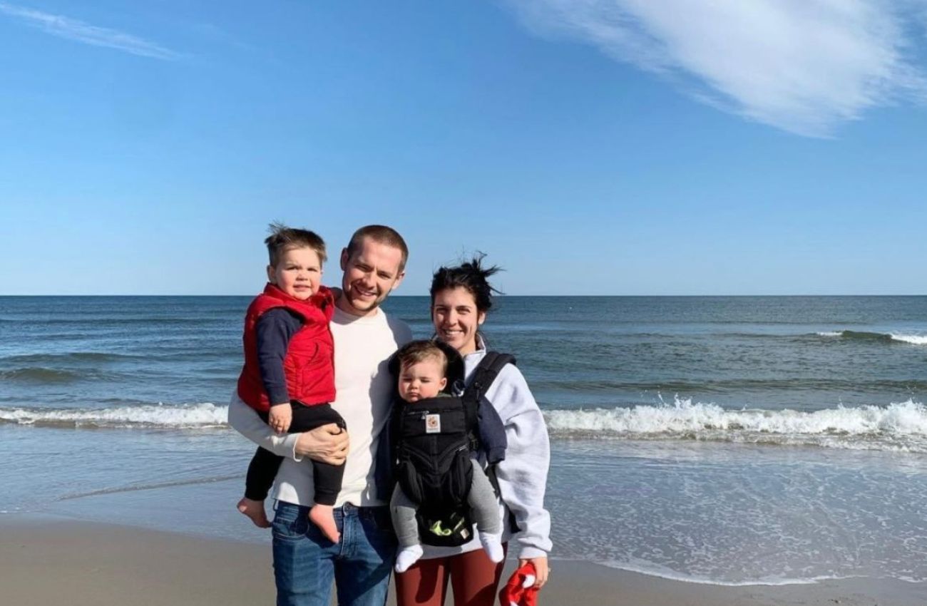 Small Moments founder, Rebecca with her husband and two kids on the beach.