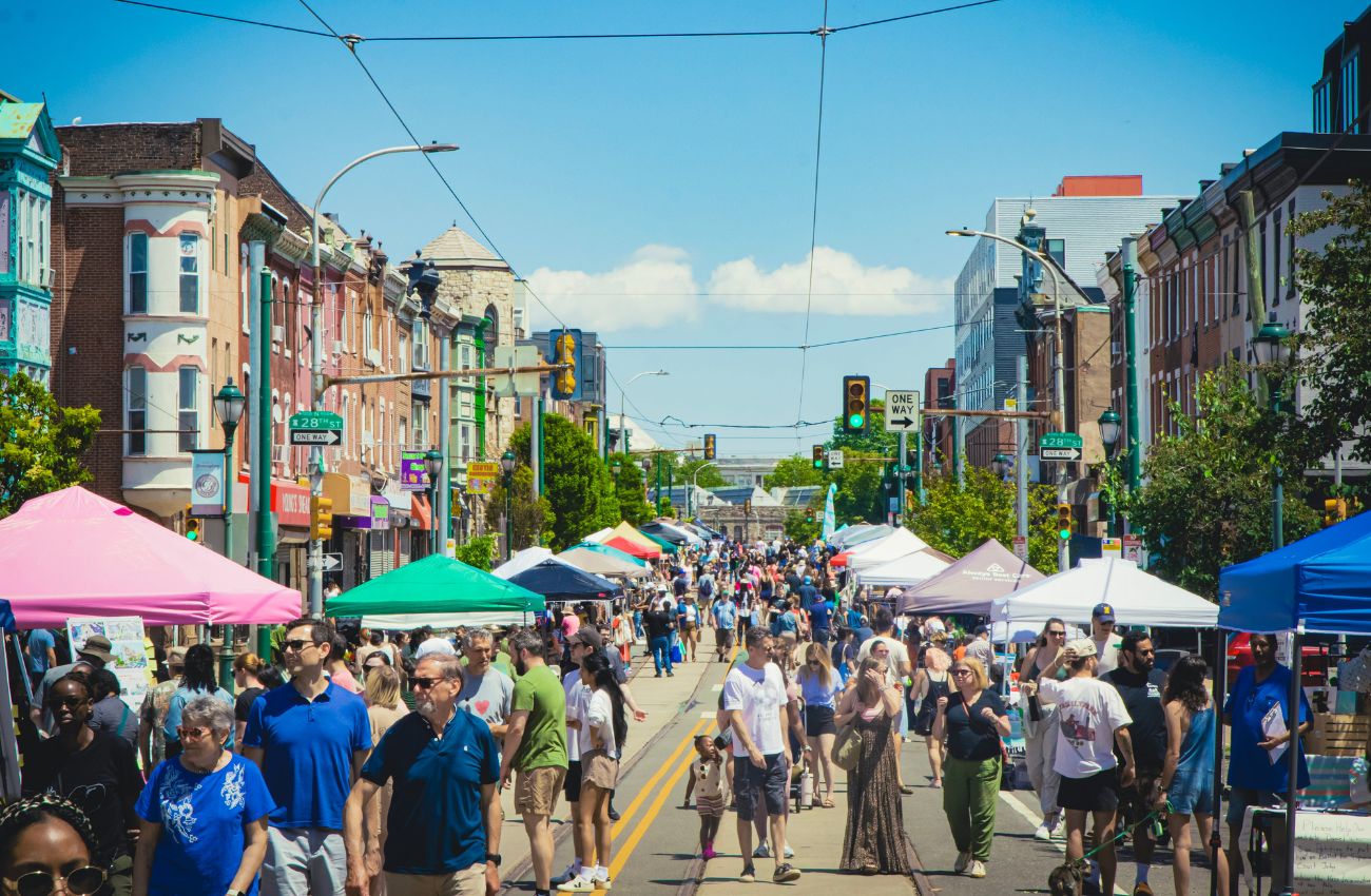 A street festival on West Girard Avenue in the Brewerytown neighborhood of Philadelphia on a sunny day.