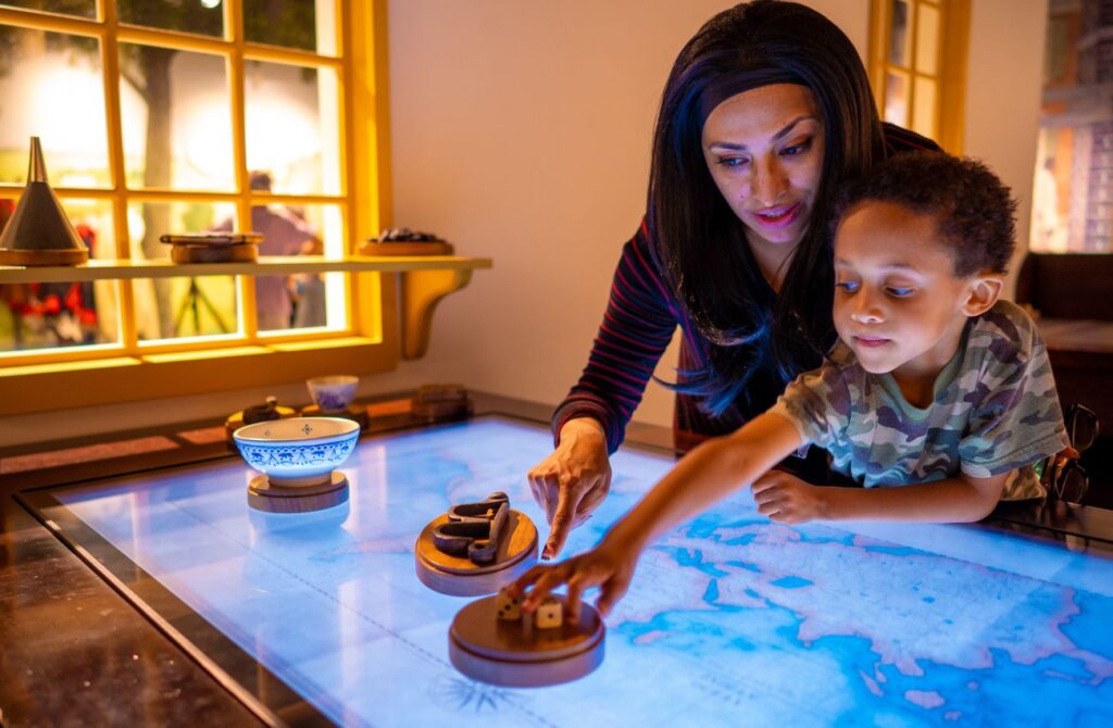 A mother and her young son look at a map in a hands on exhibit at a Philadelphia Museum. 
