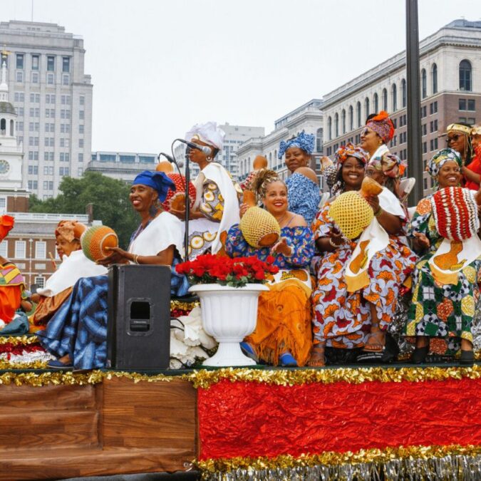 Women aboard a festive float in the Philadelphia Juneteenth parade.