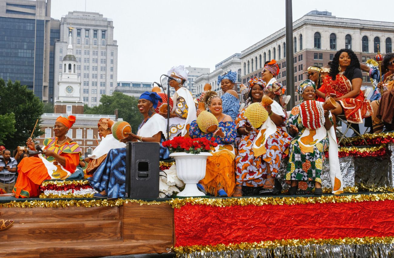 Women aboard a festive float in the Philadelphia Juneteenth parade.
