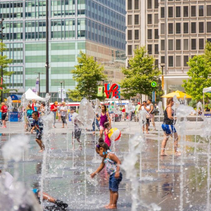 Kids cool off in the sprayground sprinklers in Dilworth Park, Philadelphia.