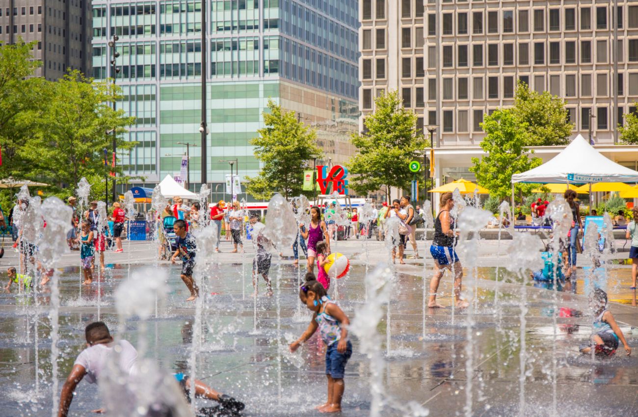 Kids cool off in the sprayground sprinklers in Dilworth Park, Philadelphia.