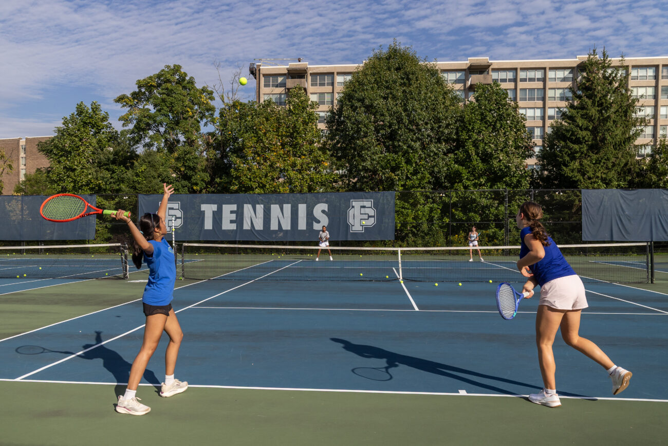 Friends' Central students playing tennis on their home courts.
