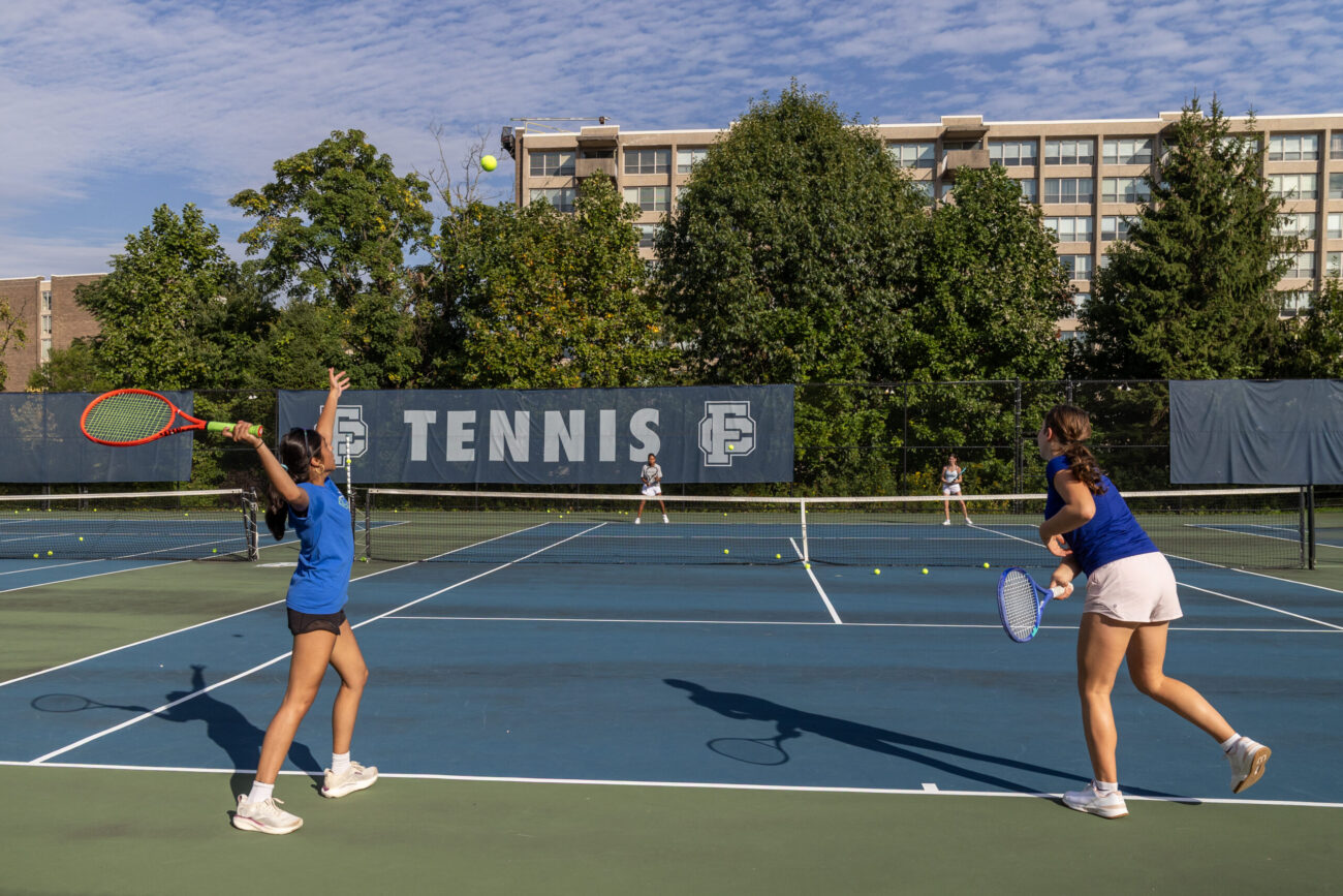 Friends' Central students playing tennis on their home courts.